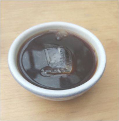 A steaming cup of black coffee